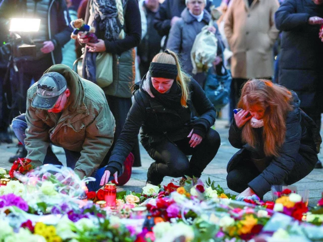 people lie candles and tributes at the site where a car drove into a crowd at a magdeburg christmas market in magdeburg germany photo reuters