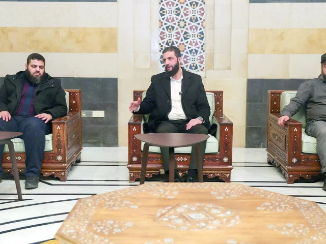 head of hayat tahrir al sham and syria s de facto leader ahmed al sharaa also known as abu mohammed al golani sits next to murhaf abu qasra in damascus photo reuters