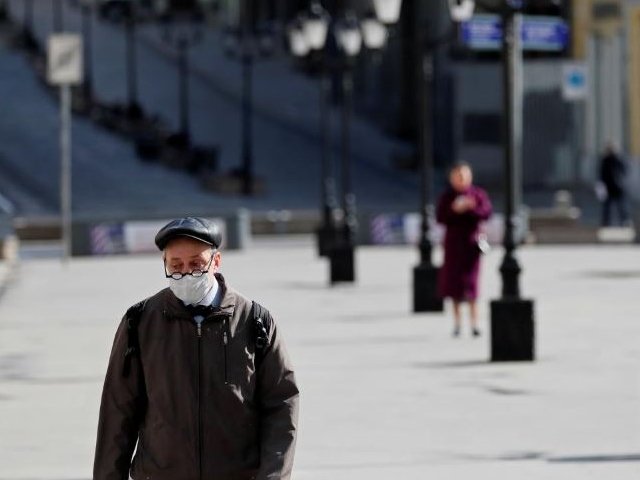 a man wearing a protective face mask walks along the street as the spread of the coronavirus disease covid 19 continues in moscow russia photo reuters
