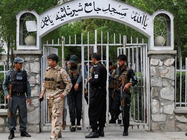 policemen inspect at the gate of a mosque after a blast in kabul afghanistan on june 12 2020 killed four worshippers photo reuters file