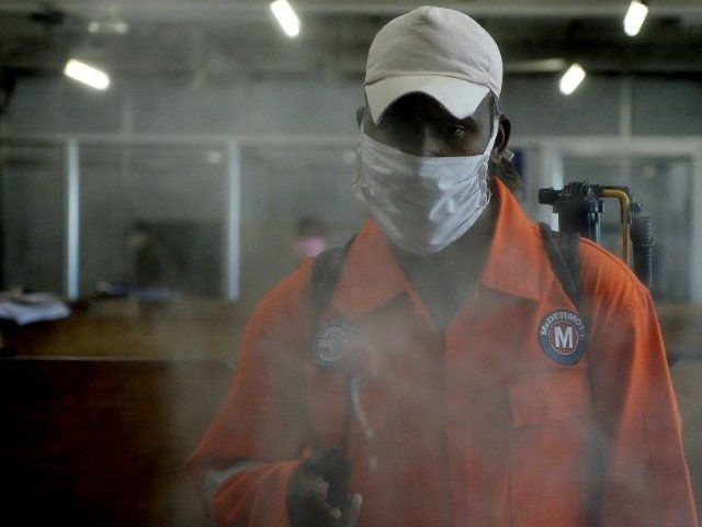 a health worker sprays disinfectant inside government offices in chennai photo afp file