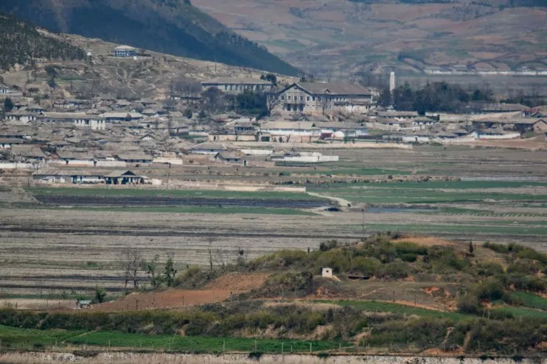 a general view of fields and buildings outside kaesong in north korea seen across the demilitarised zone from the south korean island of ganghwa photo afp a general view of fields and buildings outside kaesong in north korea seen across the demilitarised zone from the south korean island of ganghwa photo afp