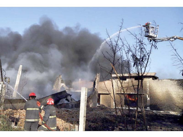 firefighters try to extinguish a fire that erupted in a cooking oil warehouse on tuesday photo app firefighters try to extinguish a fire that erupted in a cooking oil warehouse on tuesday photo app