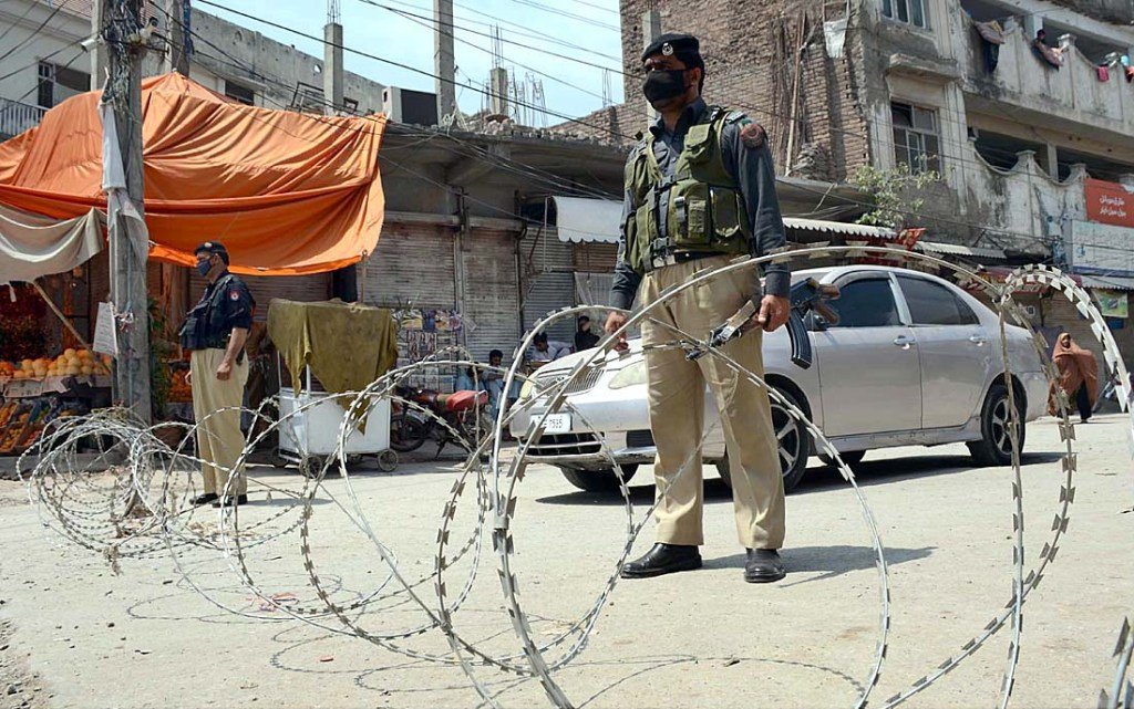 police personnel block ishrat cinema chowk in peshawar with barb wires as the khyber pakhtunkhwa government announced smart lockdown as precautionary measures to prevent covid 19 outbreak in the city photo app