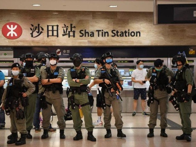 police stand at a metro station near a pro democracy protest inside the new town plaza mall in sha tin in hong kong china june 12 2020 photo reuters file police stand at a metro station near a pro democracy protest inside the new town plaza mall in sha tin in hong kong china june 12 2020 photo reuters file