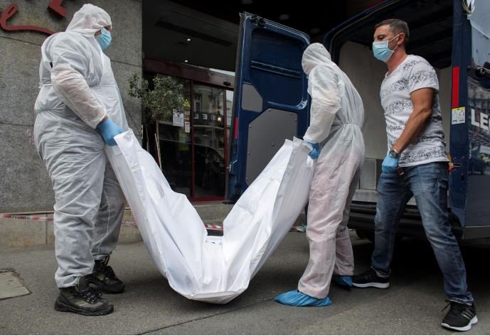 forensic medicine staff carry a body bag allegedly containing the remains of gholamreza mansouri outside a hotel in downtown bucharest romania june 19 2020 photo reuters