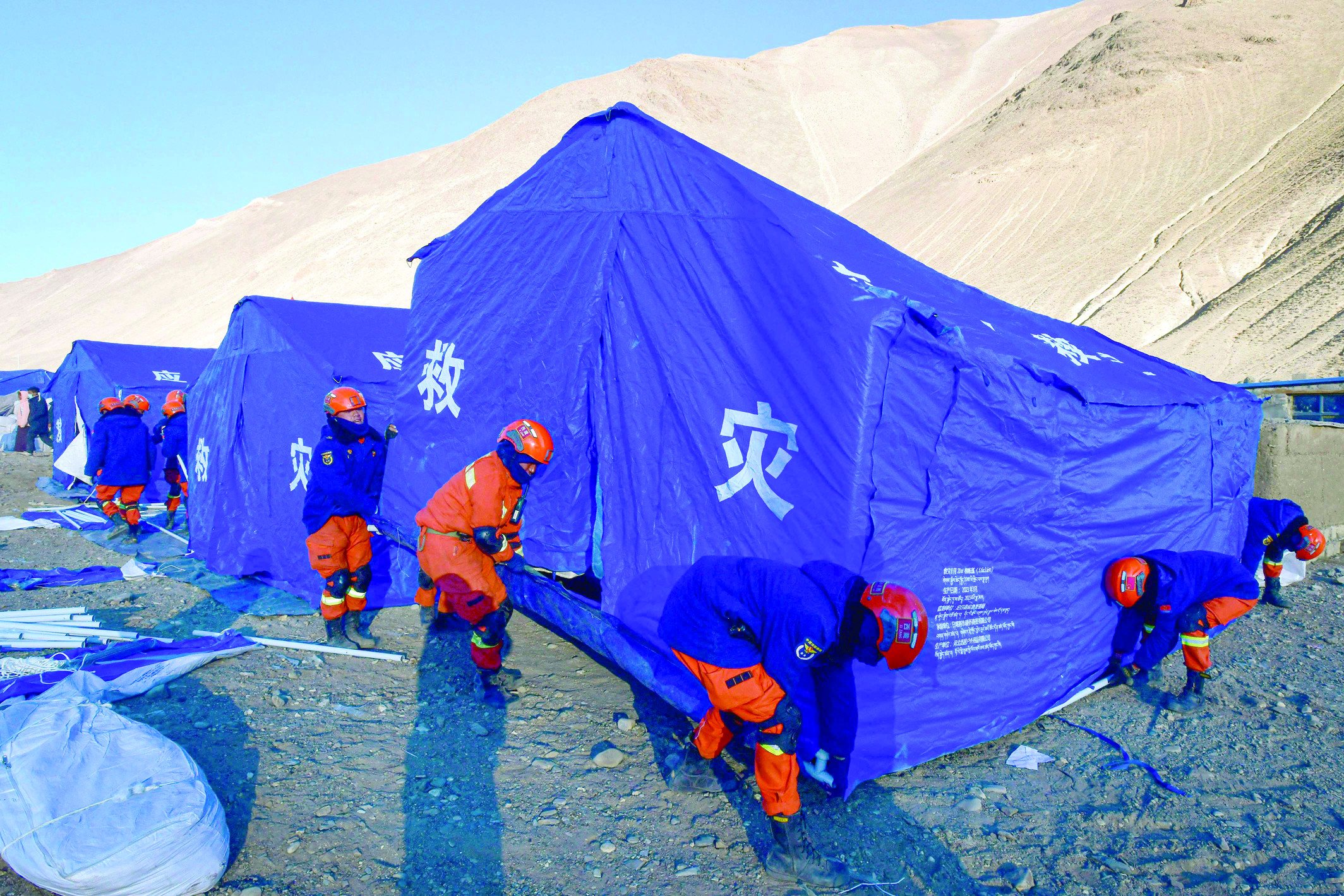 rescuers erect aid tents for people evacuated after an earthquake at cuoguo township in shigatse china s tibet region photo afp