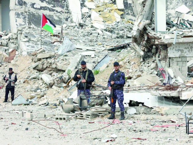 members of palestinian security forces loyal to hamas stand guard in front of a destroyed police compound in gaza city photo afp members of palestinian security forces loyal to hamas stand guard in front of a destroyed police compound in gaza city photo afp