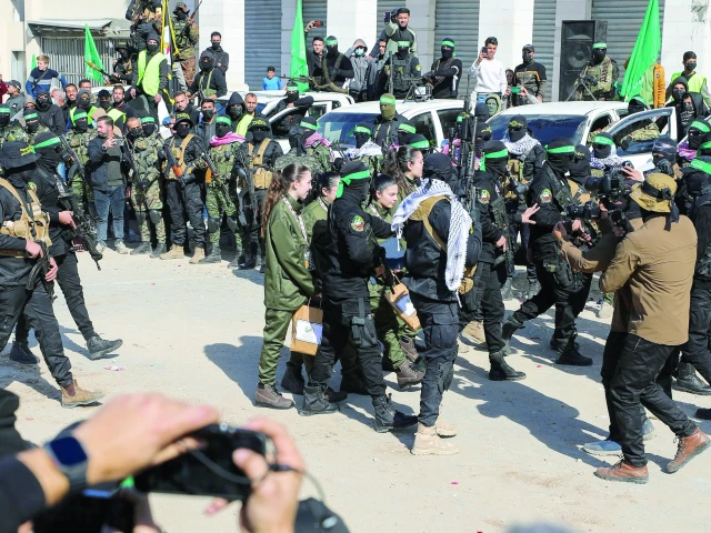 hamas fighters escort four israeli hostages to hand them over to a red cross team in gaza city photo reuters hamas fighters escort four israeli hostages to hand them over to a red cross team in gaza city photo reuters