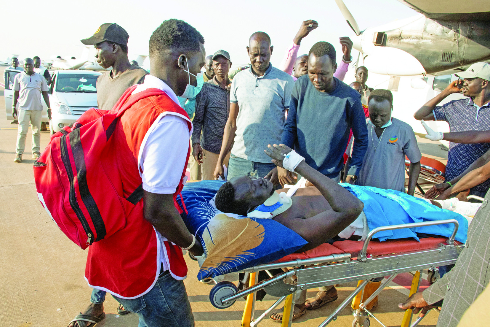 south sudan red cross workers help engineer emmanuel maker survivor of a plane crash at the unity oilfield airport after he was airlifted at the juba airport south sudan photo reuters