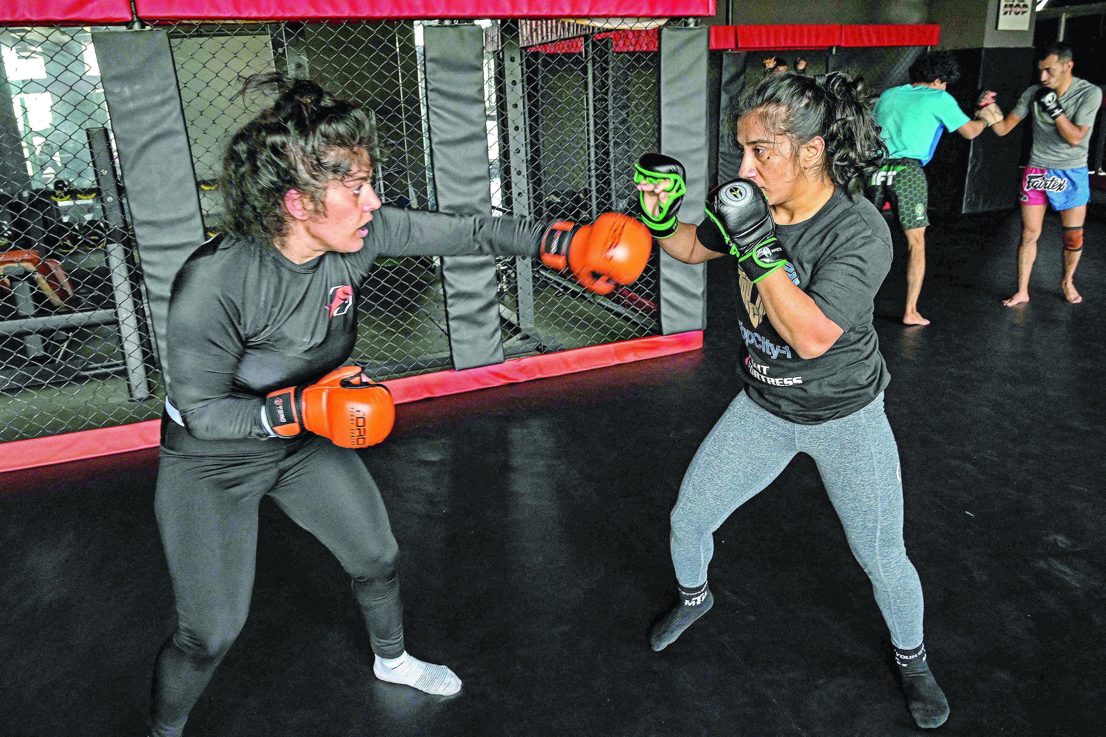 in this file photo anita karim r and bushra ahmed mixed martial arts mma fighters take part in a training session at a club in islamabad photo afp