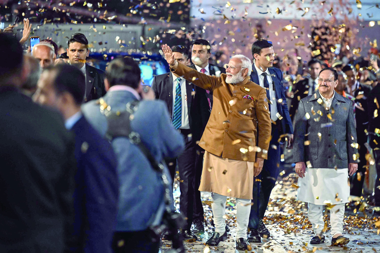 india s prime minister narendra modi waves to supporters as he arrives at the bharatiya janata party bjp headquarters to celebrate the party s win in the delhi legislative assembly election in new delhi photo afp