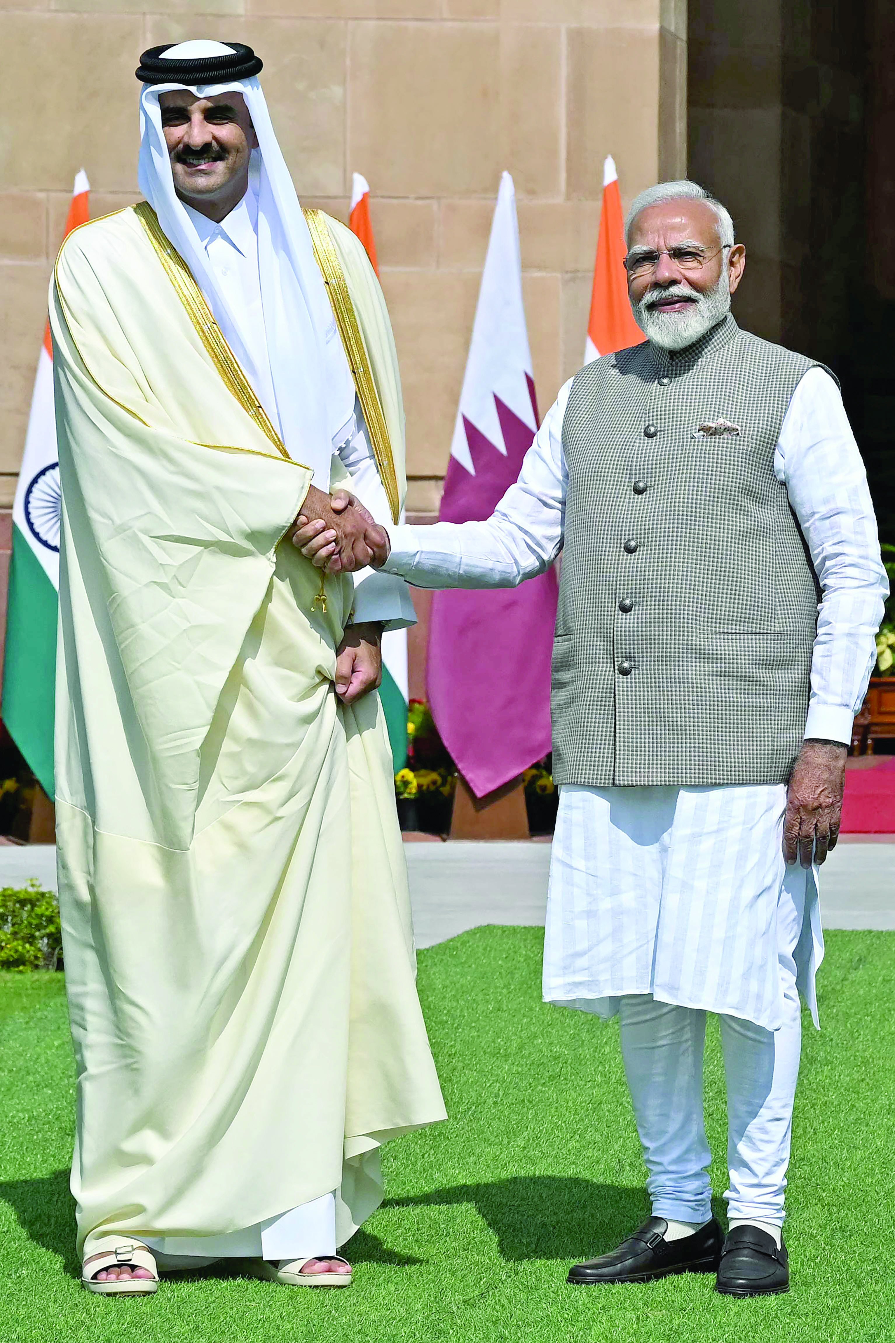 qatar s emir sheikh tamim bin hamad al thani shakes hands with india s prime minister narendra modi in new delhi photo afp