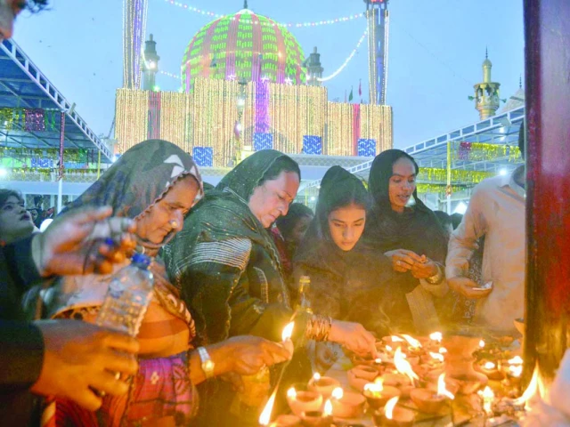 women devotees light lamps at the shrine of sufi saint lal shahbaz qalandar in hope of a wish to come true photo app