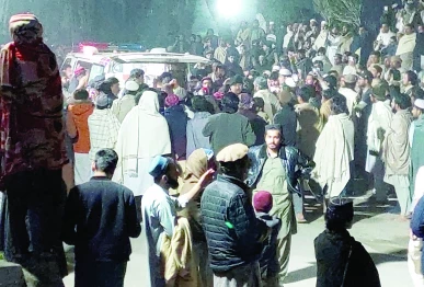 people gather near an ambulance outside a hospital in bannu photo reuters