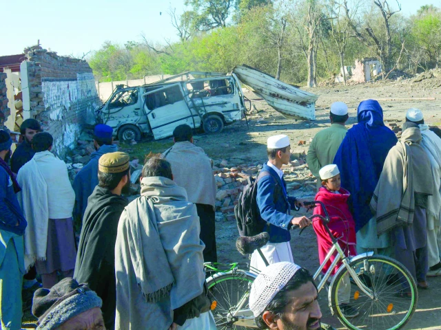 people gather near a detonated explosive laden van outside bannu cantt photo afp people gather near a detonated explosive laden van outside bannu cantt photo afp
