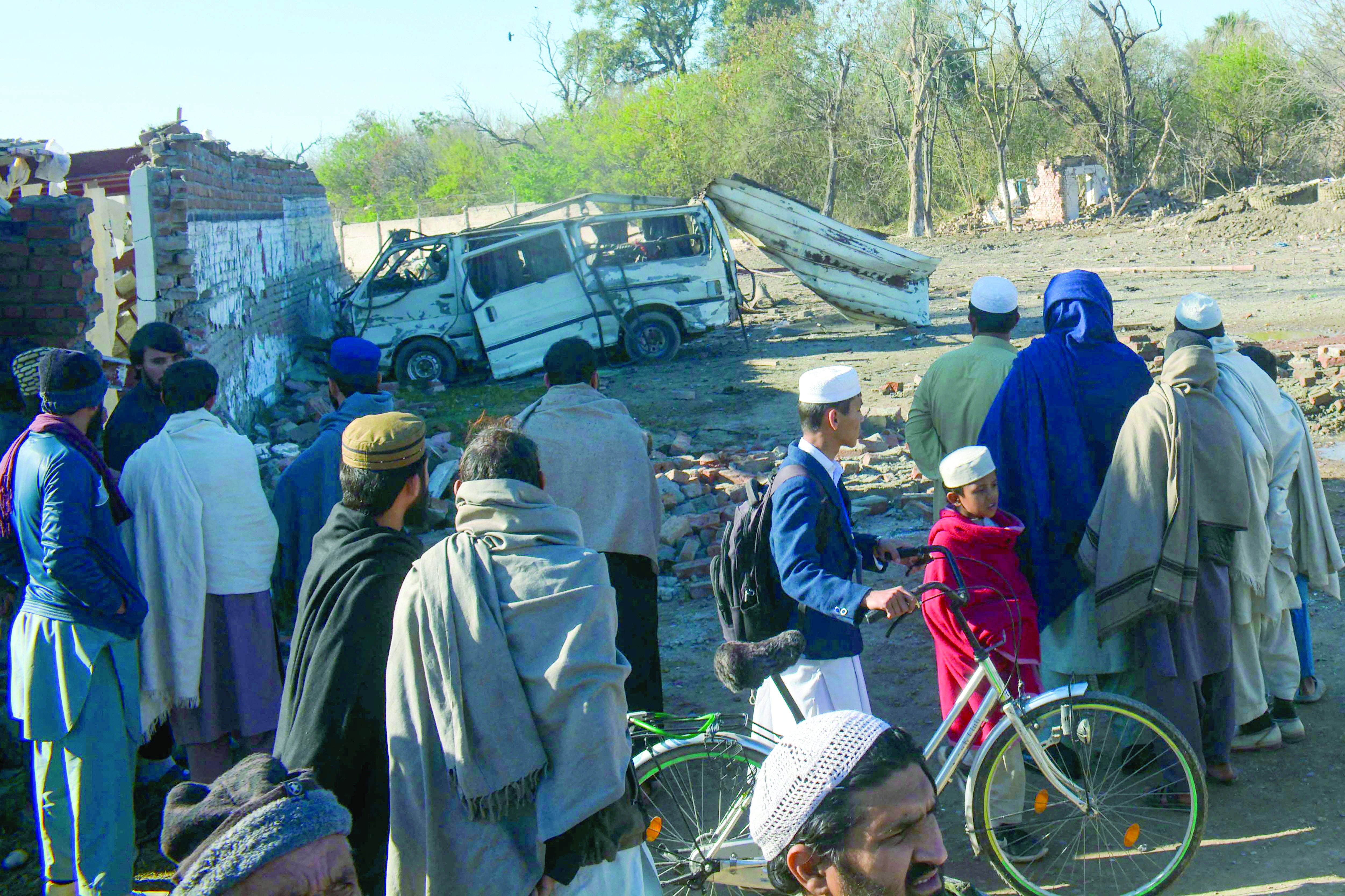 people gather near a detonated explosive laden van outside bannu cantt photo afp