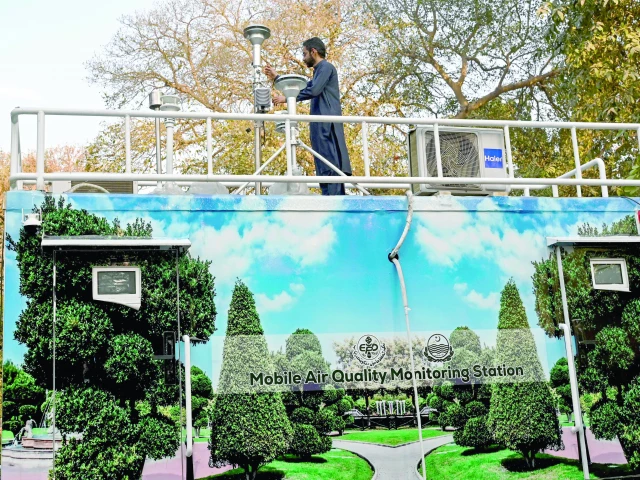 this photograph taken on february 17 shows an anti smog squad ass technician inspecting a mobile air quality monitoring station in lahore photo afp this photograph taken on february 17 shows an anti smog squad ass technician inspecting a mobile air quality monitoring station in lahore photo afp
