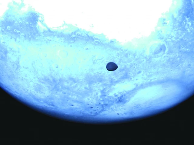 this handout photograph released by the european space agency shows the surface of mars and the face of deimos photo afp this handout photograph released by the european space agency shows the surface of mars and the face of deimos photo afp