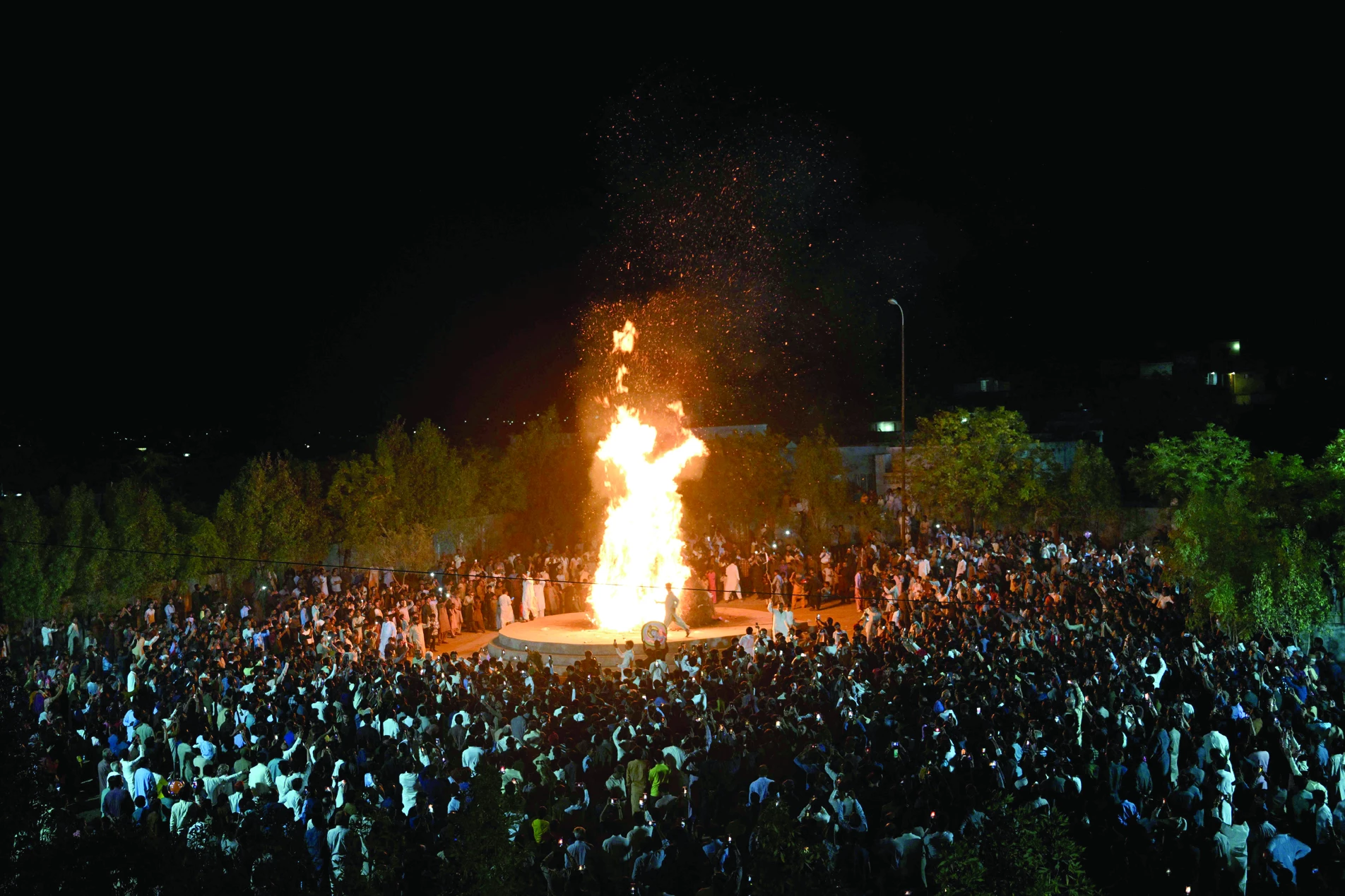 hindu community members gather around a bonfire as they celebrate the festival of colours in mithi photo afp hindu community members gather around a bonfire as they celebrate the festival of colours in mithi photo afp