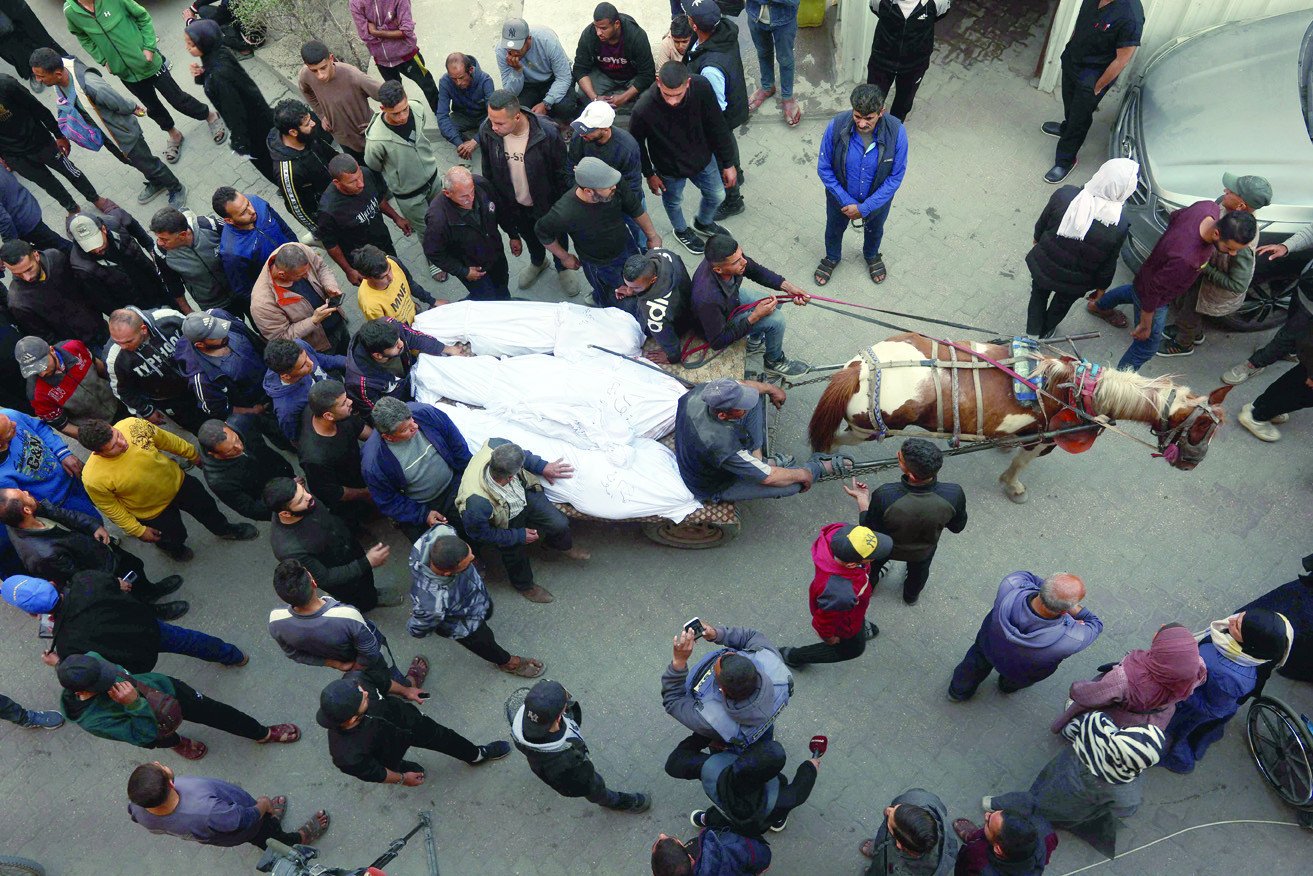 the bodies of victims killed in israeli airstrikes are carried on a horse cart outside al ahli arab hospital in gaza photo afp