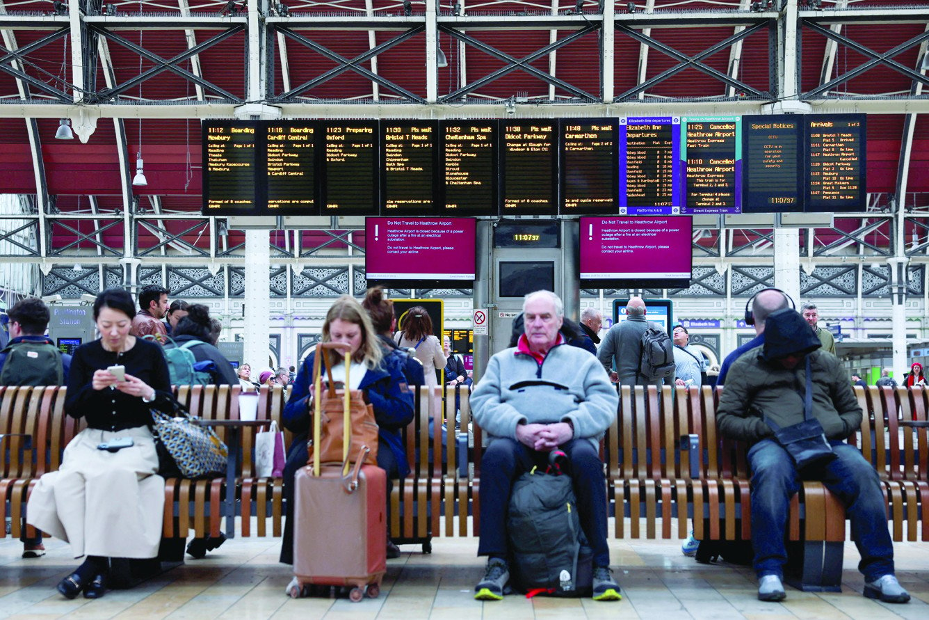 people wait at the paddington railway station after a fire at an electrical substation wiped out power at the heathrow international airport in london photo reuters