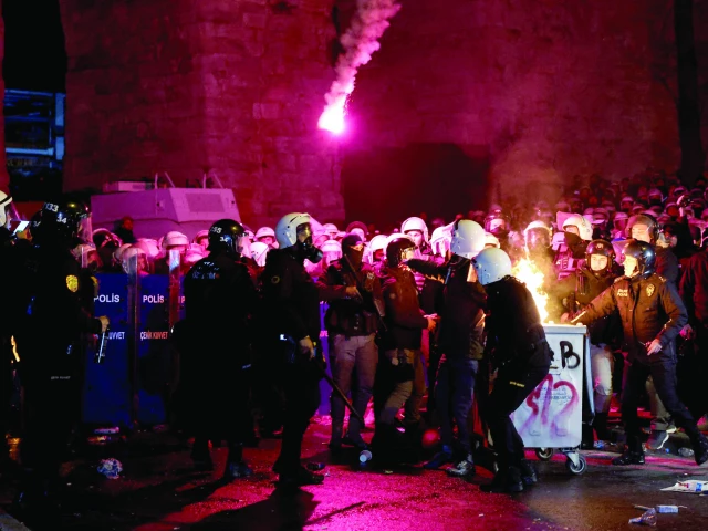 police officers intervene as flames rise from a fire in a dustbin during a protest by students against the detention of istanbul mayor ekrem imamoglu in istanbul photo reuters police officers intervene as flames rise from a fire in a dustbin during a protest by students against the detention of istanbul mayor ekrem imamoglu in istanbul photo reuters