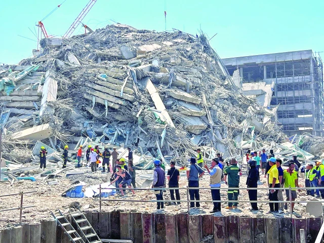rescuers work at the site of a collapsed building in bangkok photo reuters rescuers work at the site of a collapsed building in bangkok photo reuters