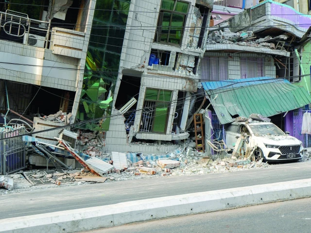 a vehicle is trapped under the rubble of a building that collapsed in the aftermath of a strong earthquake in mandalay myanmar photo reuters