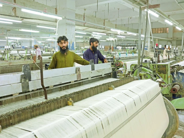 workers inspect loom machines weaving fabric at a textiles manufacturer in karachi photo reuters workers inspect loom machines weaving fabric at a textiles manufacturer in karachi photo reuters