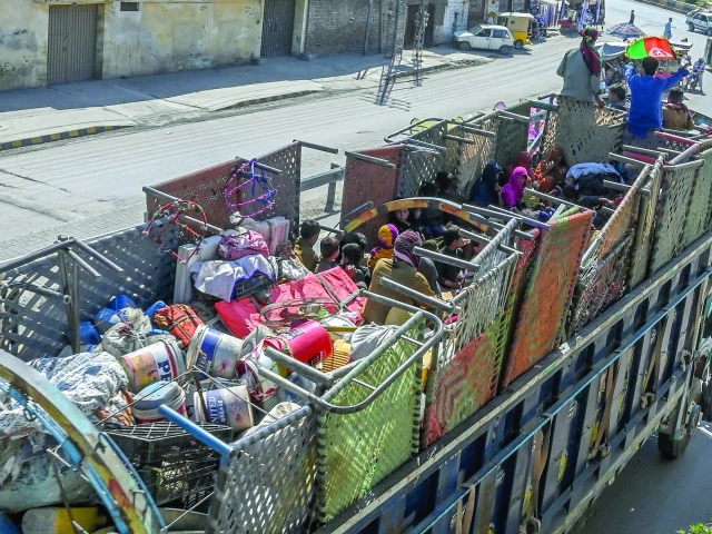 afghan refugee families sitting in a truck with their belongings head towards afghanistan in peshawar photo afp
