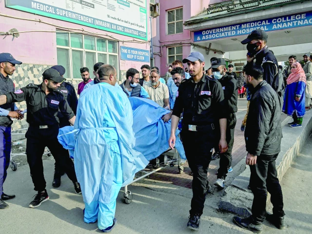paramedics and police personnel shift an injured tourist to a hospital in anantnag photo afp paramedics and police personnel shift an injured tourist to a hospital in anantnag photo afp