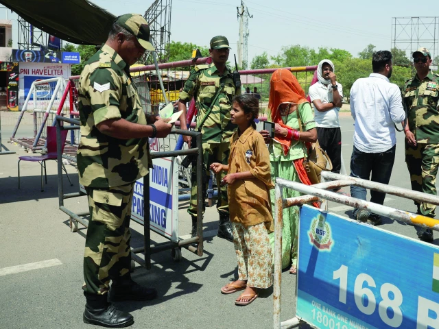 border security force personnel checks the passports of pakistani citizens as they prepare to leave india at the attari wagah border crossing near amritsar photo reuters border security force personnel checks the passports of pakistani citizens as they prepare to leave india at the attari wagah border crossing near amritsar photo reuters
