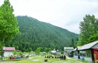 guest house staff sit inside an empty tourist place in keran village on the loc in neelum valley ajk photo afp