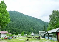 guest house staff sit inside an empty tourist place in keran village on the loc in neelum valley ajk photo afp