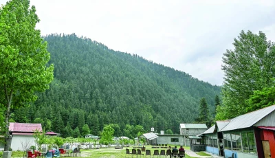 guest house staff sit inside an empty tourist place in keran village on the loc in neelum valley ajk photo afp