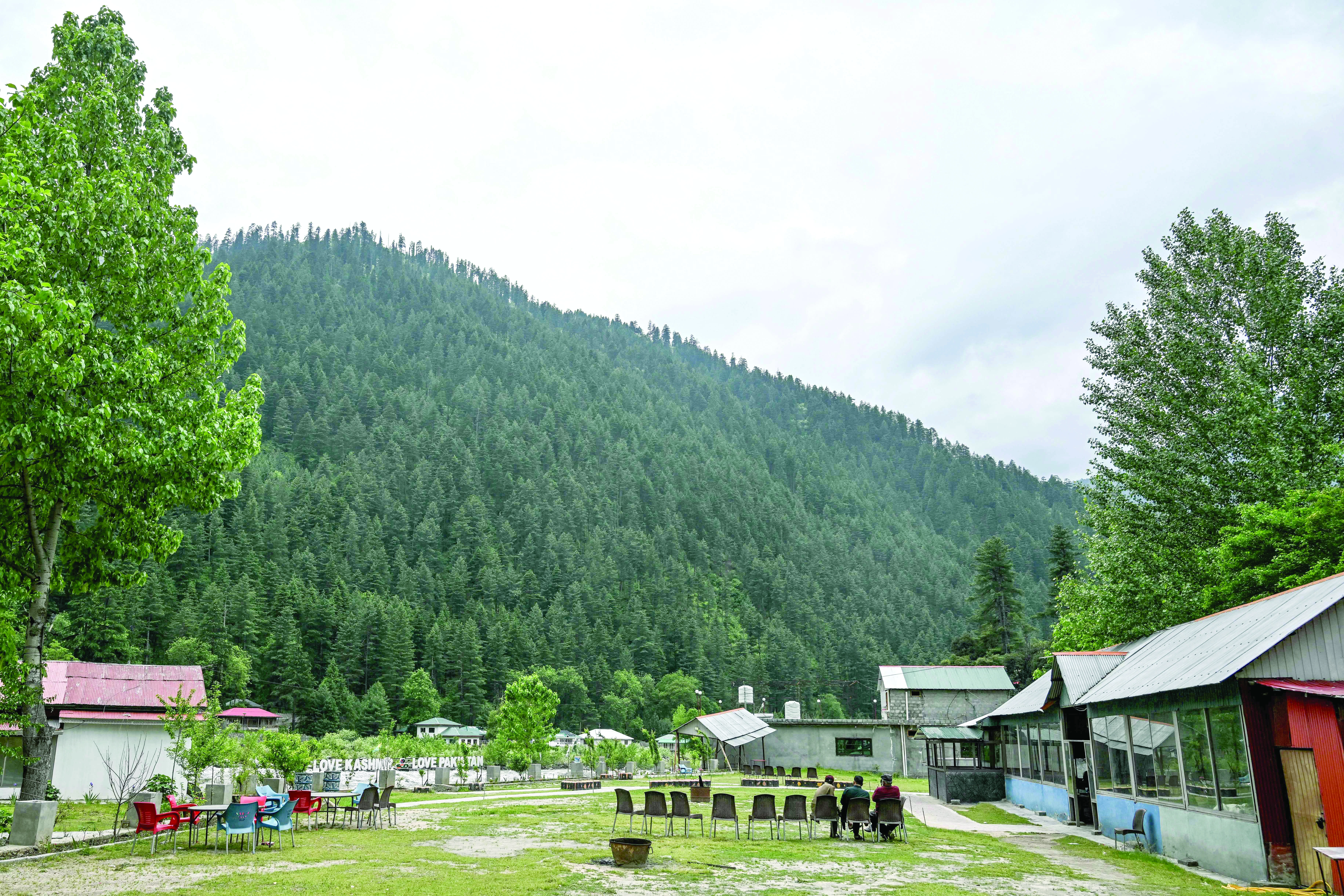guest house staff sit inside an empty tourist place in keran village on the loc in neelum valley ajk photo afp guest house staff sit inside an empty tourist place in keran village on the loc in neelum valley ajk photo afp