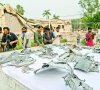 journalists look at the shards of indian missiles that hit the government health and educational complex in muridke photo afp