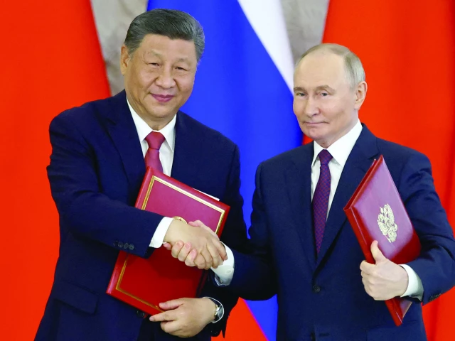 russian president vladimir putin shakes hands with his chinese counterpart xi jinping at the kremlin in moscow photo reuters russian president vladimir putin shakes hands with his chinese counterpart xi jinping at the kremlin in moscow photo reuters
