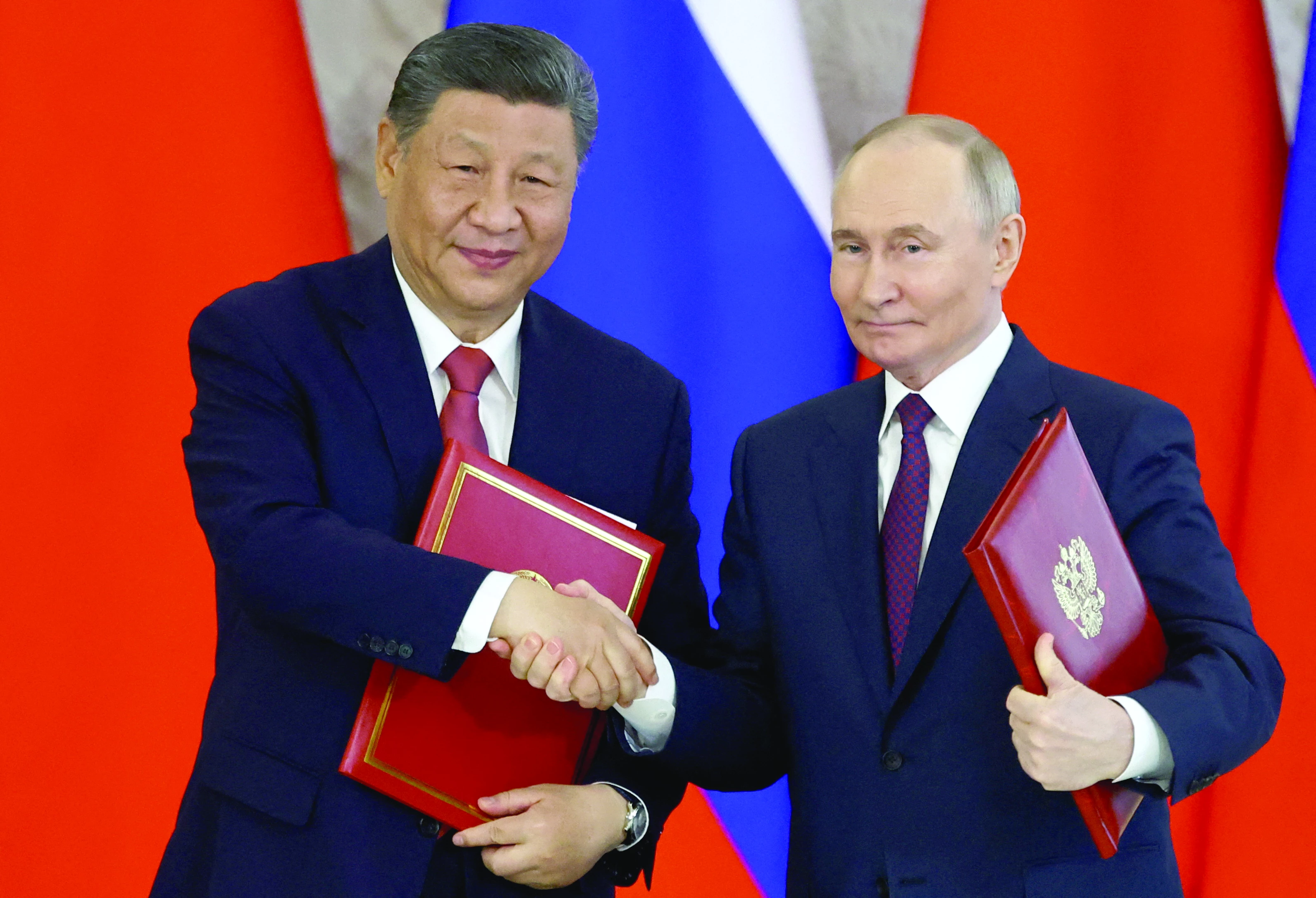 russian president vladimir putin shakes hands with his chinese counterpart xi jinping at the kremlin in moscow photo reuters russian president vladimir putin shakes hands with his chinese counterpart xi jinping at the kremlin in moscow photo reuters