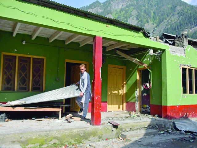 a man inspects his damaged house following cross border shelling in jura village along the line of control in neelum valley photo afp a man inspects his damaged house following cross border shelling in jura village along the line of control in neelum valley photo afp