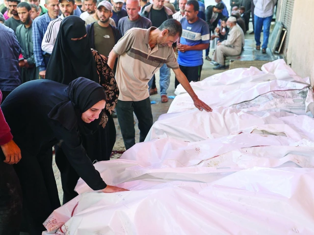 people mourn over the bodies of palestinians killed in israeli strikes at the al aqsa martyrs hospital in deir el balah in gaza photo afp people mourn over the bodies of palestinians killed in israeli strikes at the al aqsa martyrs hospital in deir el balah in gaza photo afp