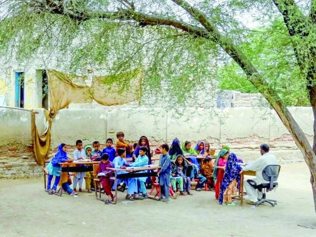 students attend a class under a tree on the outskirts of sukkur known for its hot weather photo file afp students attend a class under a tree on the outskirts of sukkur known for its hot weather photo file afp