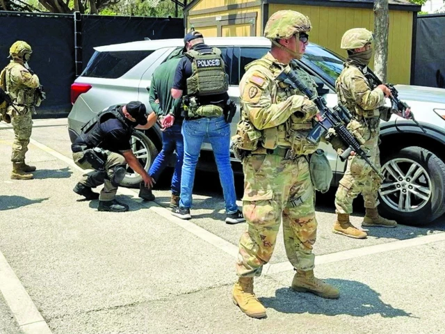 police officers detain a person next to members of the national guard at a location given as los angeles photo reuters police officers detain a person next to members of the national guard at a location given as los angeles photo reuters