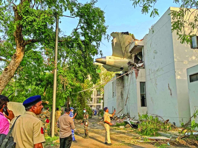 the tail of air india flight 171 is pictured at the site after it crashed in a residential area near the airport in ahmedabad photo afp the tail of air india flight 171 is pictured at the site after it crashed in a residential area near the airport in ahmedabad photo afp