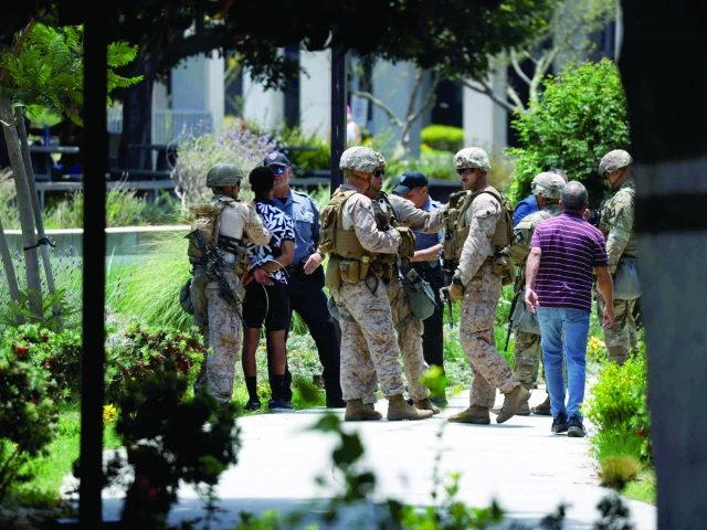 a man is detained by us marines and members of the national guard at the wilshire federal building in los angeles photo afp a man is detained by us marines and members of the national guard at the wilshire federal building in los angeles photo afp