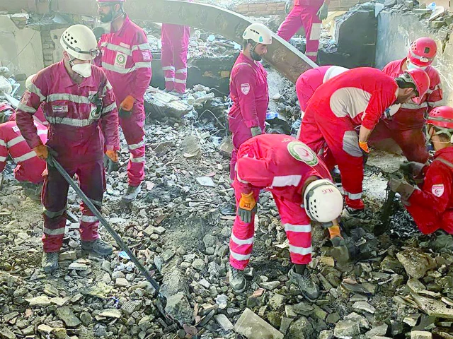 members of the iranian red crescent teams search debris inside a buidling in tehran targeted by israeli strikes photo afp members of the iranian red crescent teams search debris inside a buidling in tehran targeted by israeli strikes photo afp