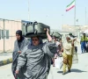 pakistanis carrying their belongings walk across the pakistan iran border after in taftan photo afp pakistanis carrying their belongings walk across the pakistan iran border after in taftan photo afp