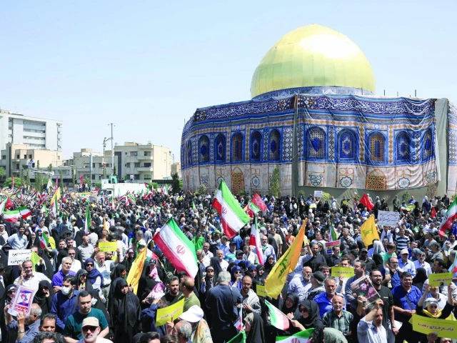 iranians wave the national flag and chant slogans next to a replica of the dome of the rock mosque during an anti israeli rally in tehran photo afp iranians wave the national flag and chant slogans next to a replica of the dome of the rock mosque during an anti israeli rally in tehran photo afp