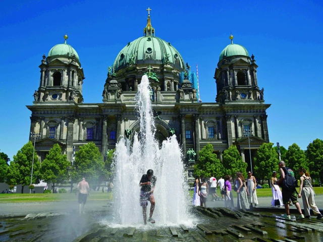 people refresh themselves in the cool water of a fountain in front of the cathedral at the lustgarten park on museum island in berlin photo afp people refresh themselves in the cool water of a fountain in front of the cathedral at the lustgarten park on museum island in berlin photo afp